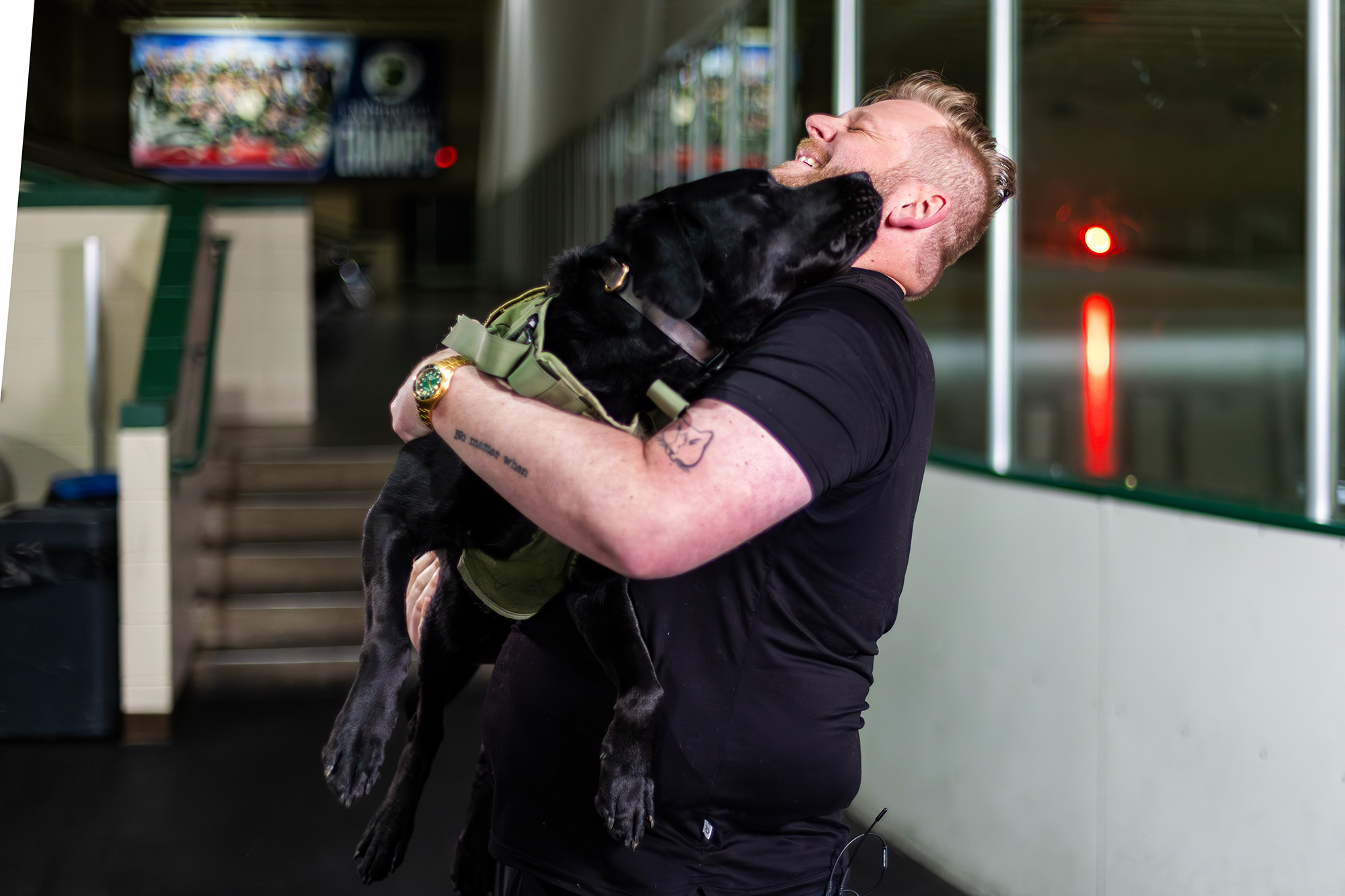 Sean, a veteran, hugs his service dog, Chips
